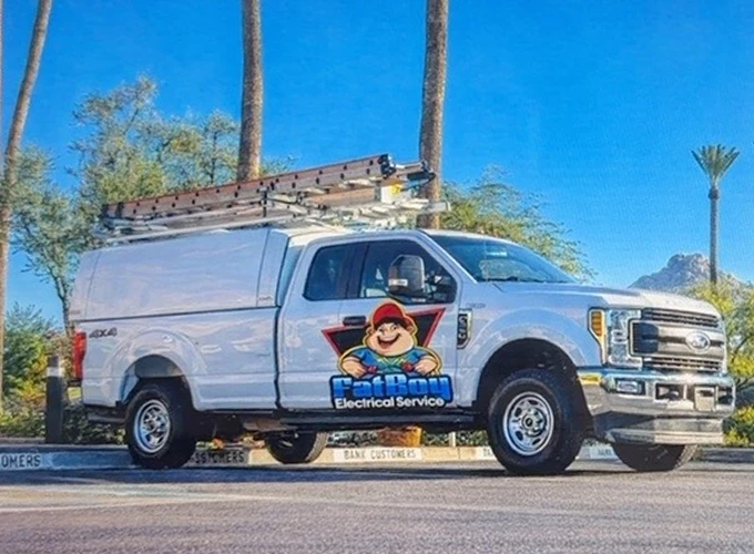 Fatboy branded white service truck with a ladder rack